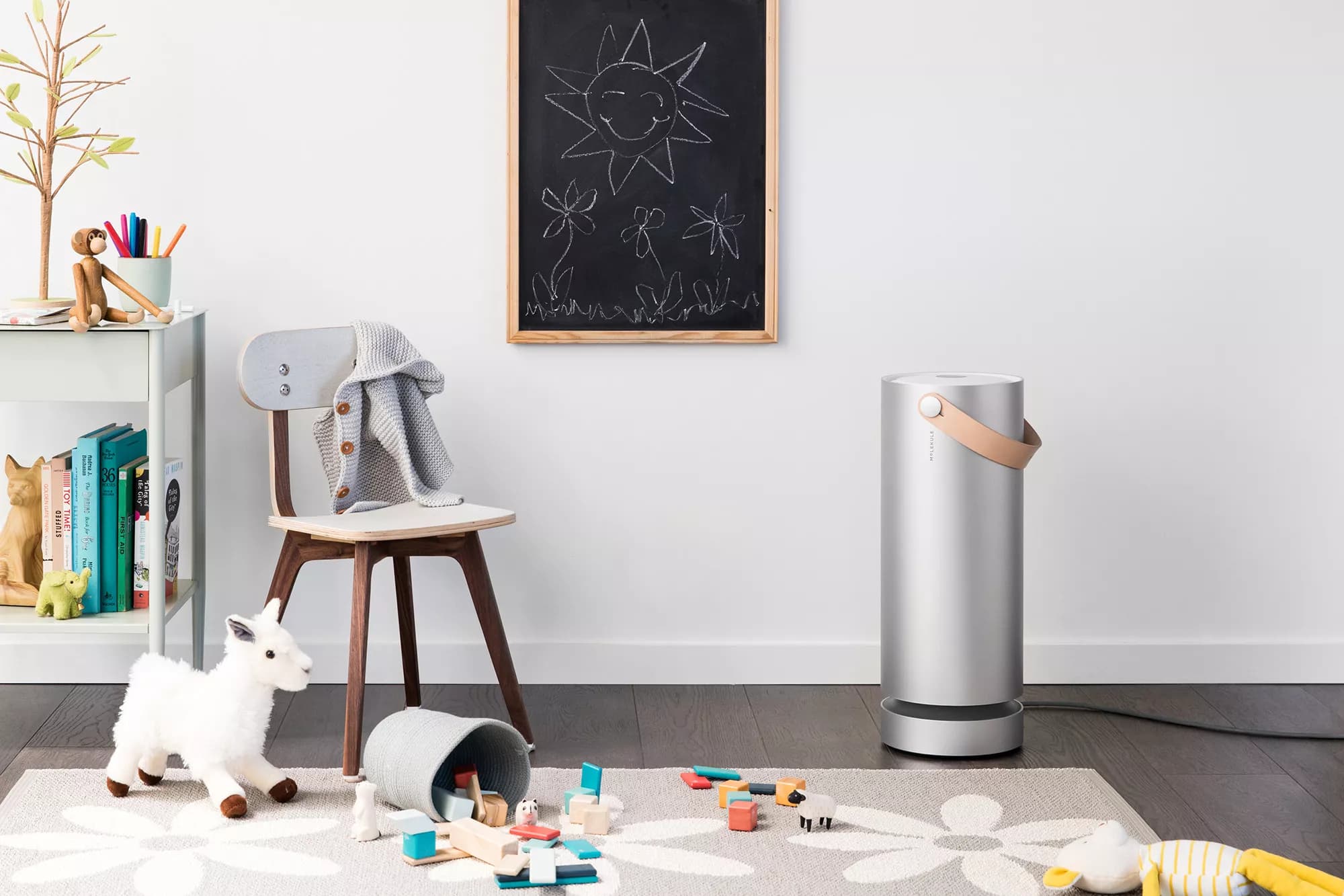Silver Molekule air purifier standing in a bright children's playroom